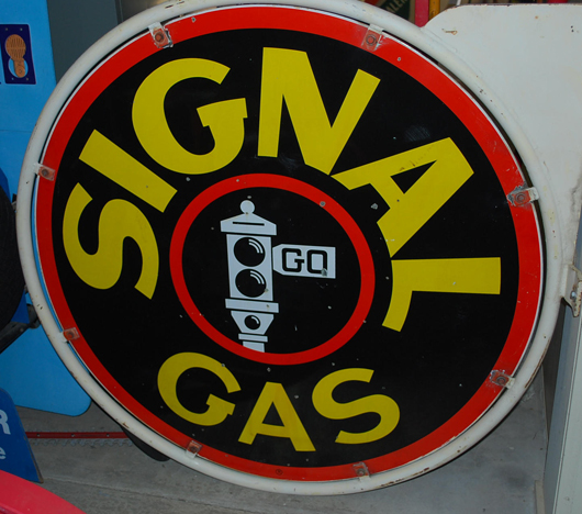 Signal Gas double-sided porcelain sign with holder, black stoplight graphic, rated 8, $4,600. Matthews Auctions image.